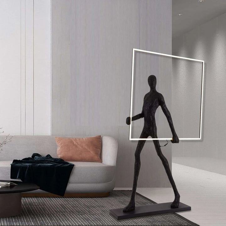 Man posing with a square LED light strip in a modern living room, highlighting ambient lighting and geometric design in contemporary decor