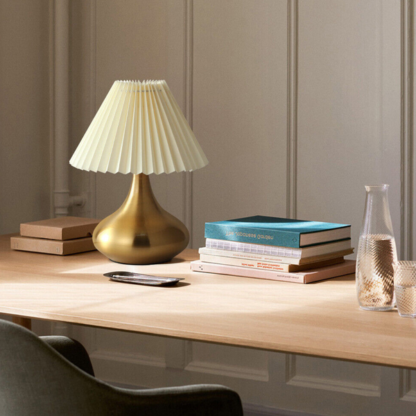 Mushroom-shaped modern bedside table lamp on table, sleek design with warm ambient lighting for bedrooms