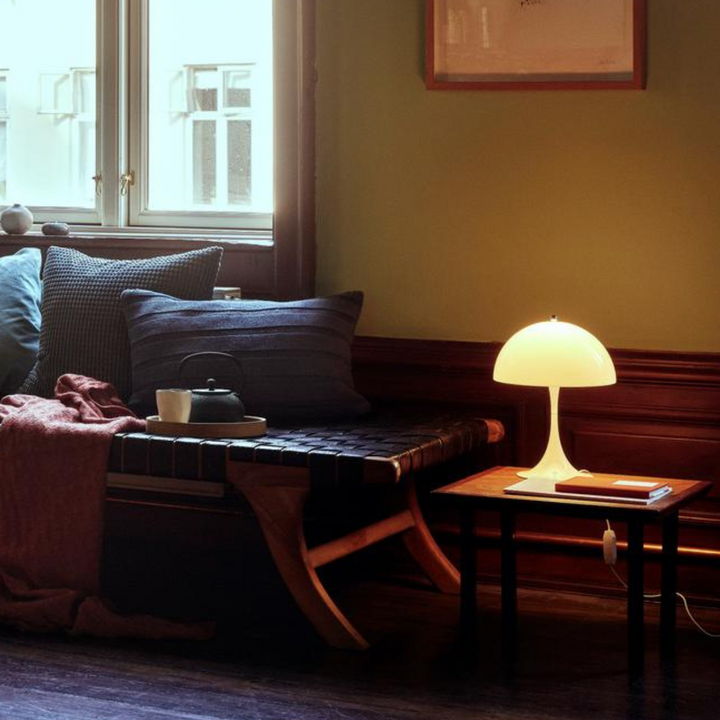 Orelli umbrella-shaped LED bedside table light on, providing warm and elegant ambient illumination