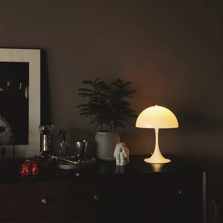 Orelli umbrella-shaped LED bedside table light glowing at night, creating warm ambient lighting