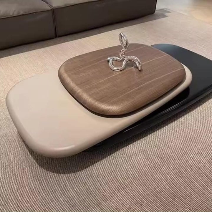 Upper side view of pebble-shaped coffee table showcasing smooth natural wood surface and organic rounded design
