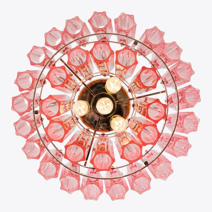 Detail view from below of Piccolo Palermo chandelier in living room, showcasing intricate design and warm glow