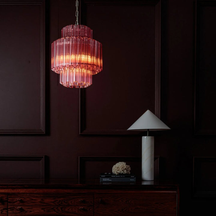 Piccolo Palermo chandelier hanging above living room table, providing elegant lighting and modern design