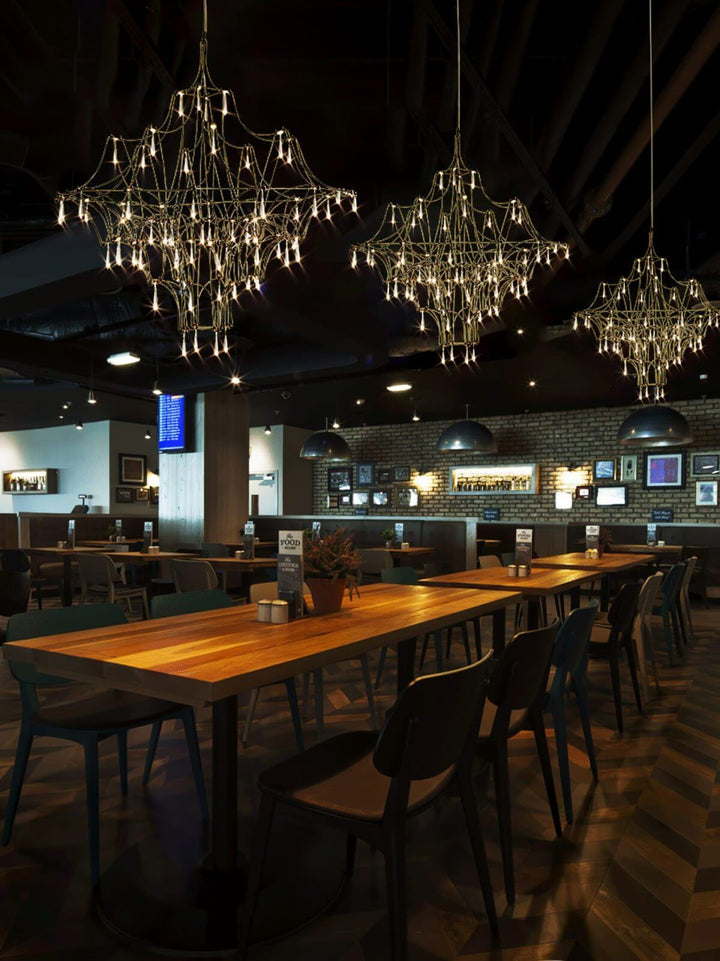 Prism premium Asfour crystal chandelier illuminated in elegant restaurant interior, creating a warm and luxurious ambiance