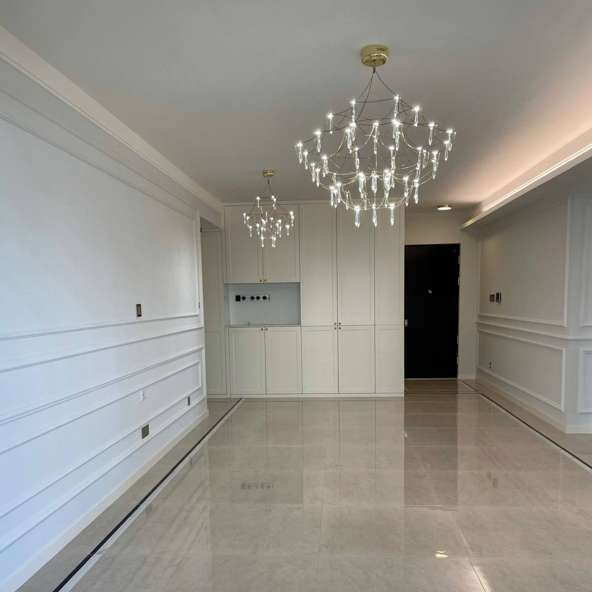 Prism premium Asfour crystal chandelier hanging in duplex stairwell, showcasing elegant design and sparkling crystals in luxury interior