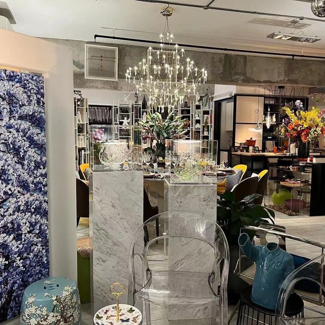 Prism premium Asfour crystal chandelier illuminated in elegant restaurant interior, creating a warm and luxurious ambiance