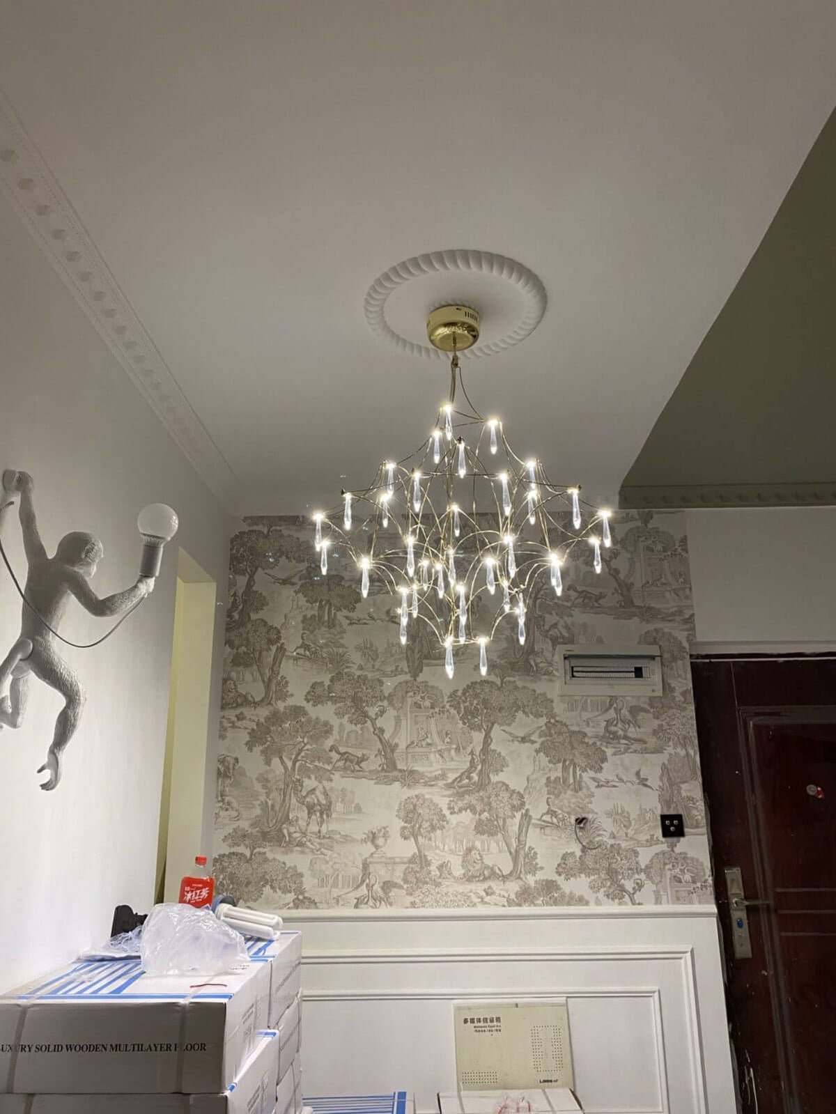rism premium Asfour crystal chandelier illuminated in elegant living room, casting sparkling light and enhancing luxurious ambiance