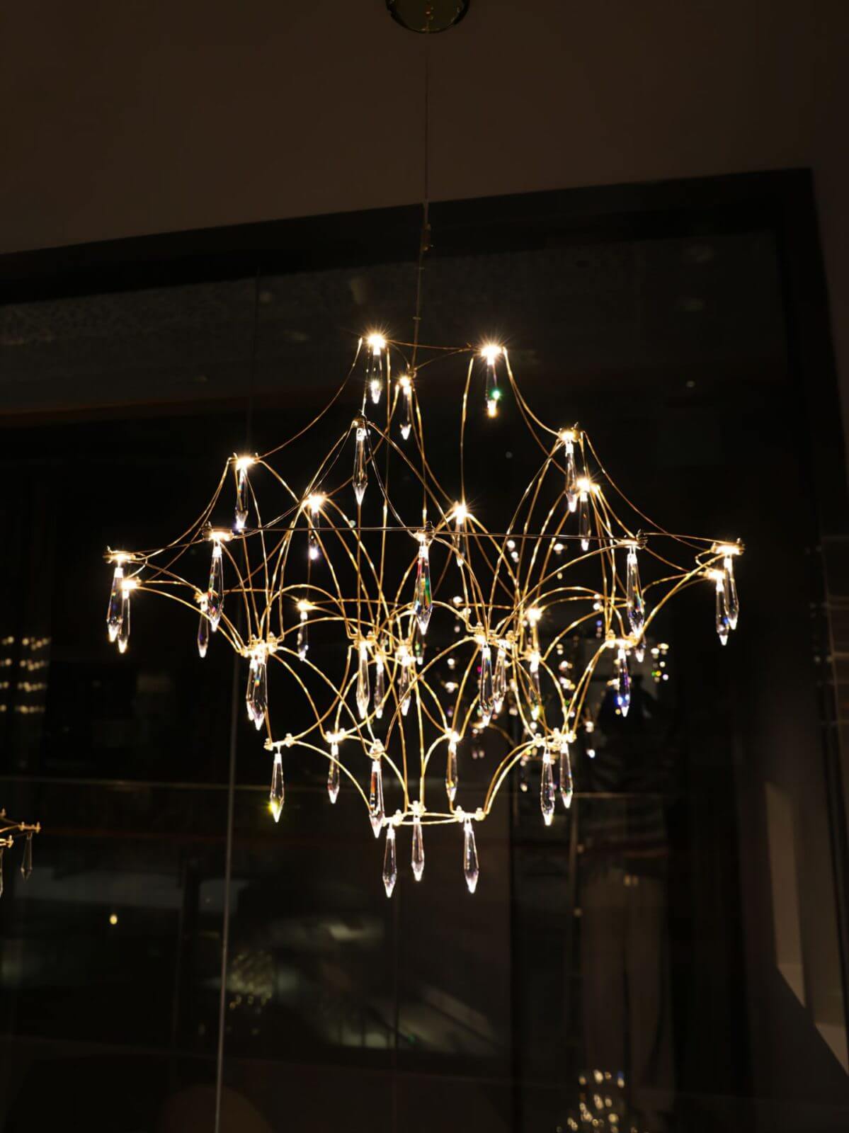 Prism premium Asfour crystal chandelier glowing at night, showcasing precious sparkle and elegant design in a luxurious interior