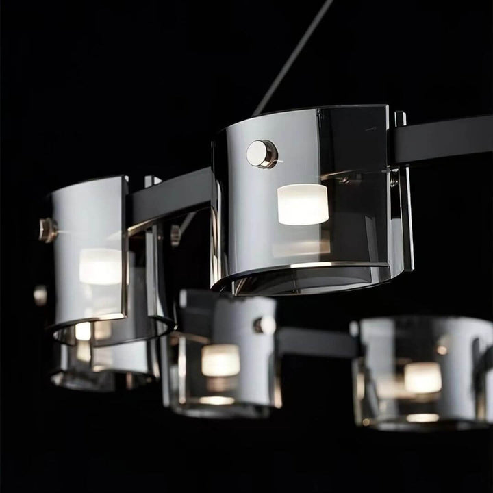 Close-up detail view of Scintillate black and gold chandelier, showcasing intricate metalwork and sparkling crystal accents
