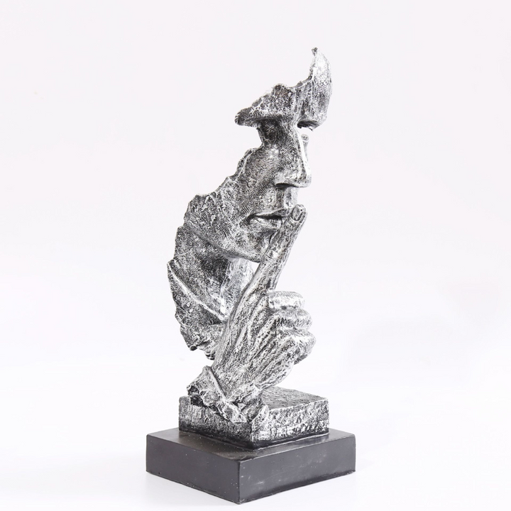 Detailed view of golden accents on Silence Is Golden sculpture