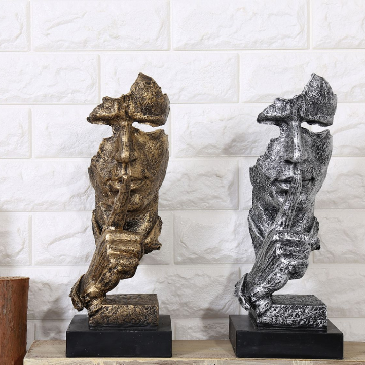 Silence Is Golden resin sculpture with golden and silver accents