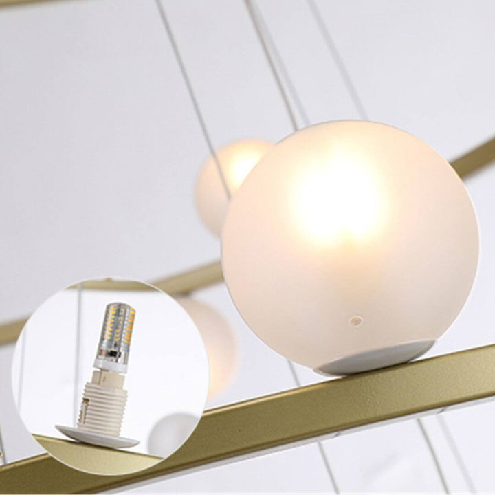 Close-up detail of Spectrum Half-Ring chandelier light glass shade with G9 bulb, showcasing sleek design and bright illumination