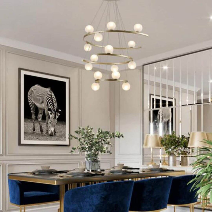 Spectrum chandelier light hanging above dining table in Australia, creating vibrant ambiance and modern style