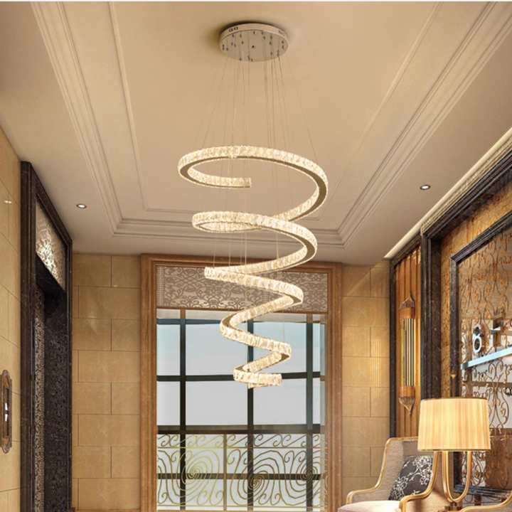 Elegant spiral chandelier adding luxury lighting to spacious living room