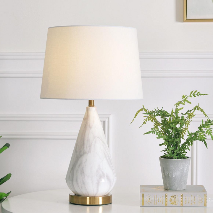 Elegant Sterling table lamp with diamond marble base displayed on side table