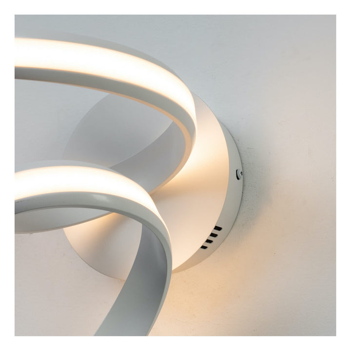 Close-up detail of white LED spiral ribbon wall light Lara in elegant interior setting