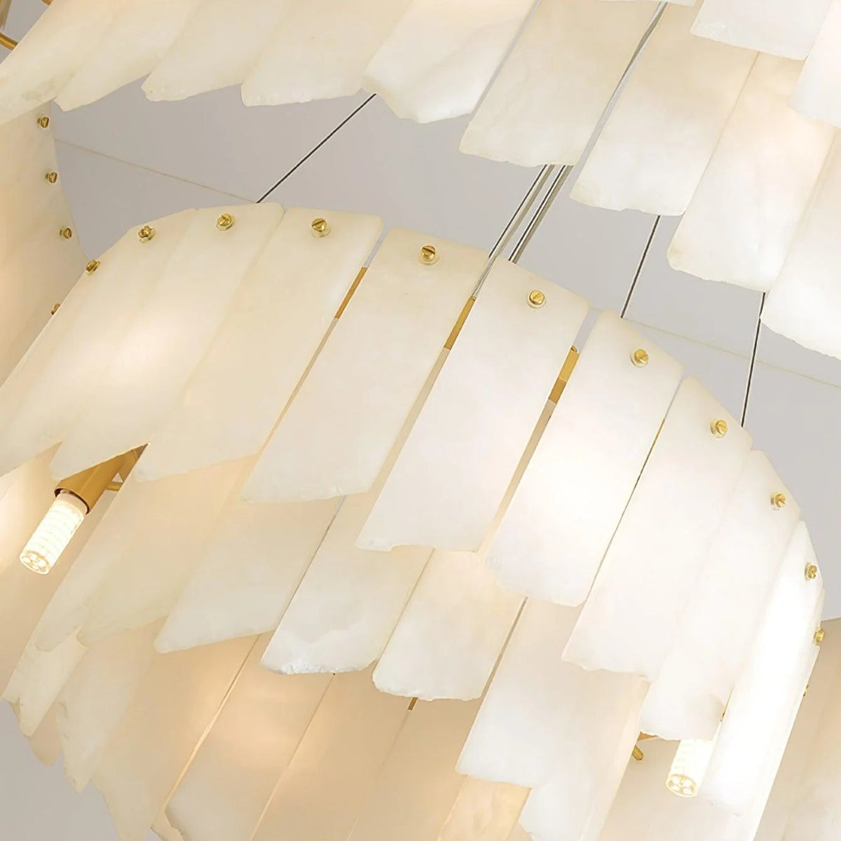 Alabaster cascade tiered chandelier lighting, round design, close-up view highlighting elegant details