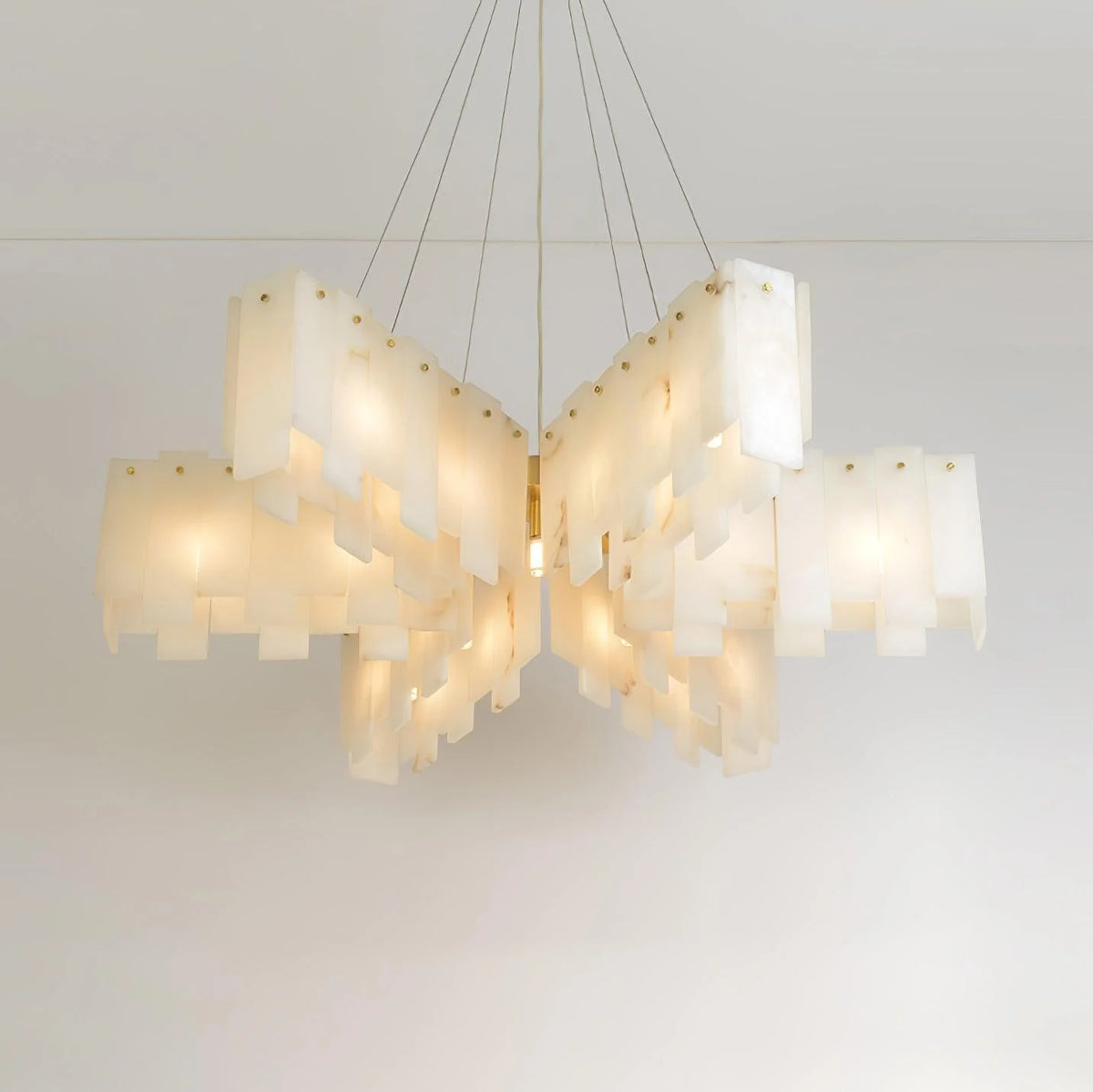 Alabaster cascade tiered chandelier lighting with star-shaped design shown from front angle view in elegant interior