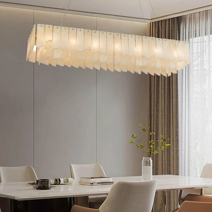  Alabaster cascade tiered chandelier lighting illuminating a stylish modern dining room interior view