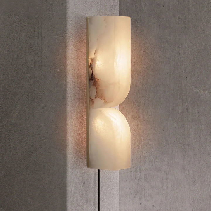 Elegant Alabaster Essence wall sconce side view glowing for home ambiance