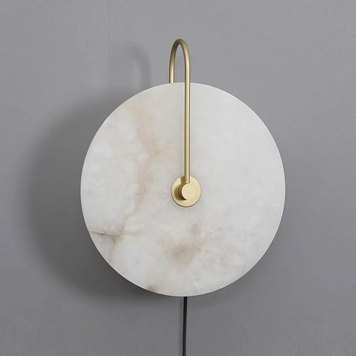 Front view of alabaster LED plug-in wall lamp with warm diffused light and natural stone pattern