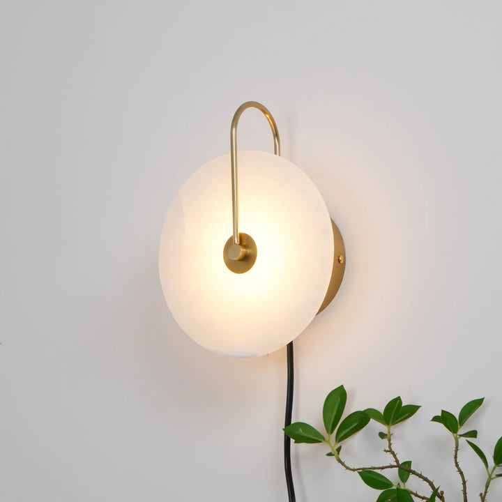 Front view alabaster LED plug-in wall lamp with warm light and natural stone texture