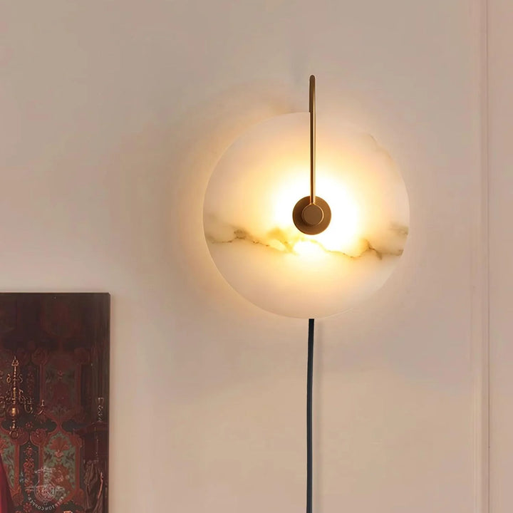 Front view of alabaster LED plug-in wall lamp with warm light and natural stone veining.