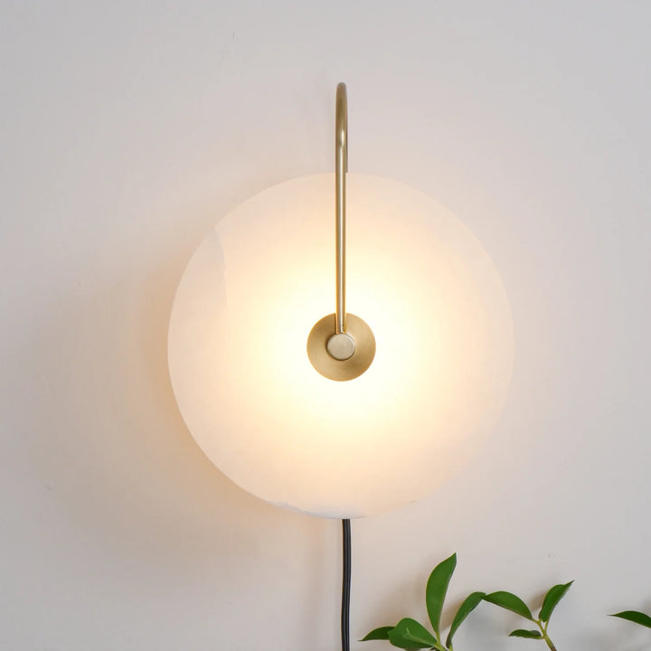 Front view alabaster LED plug-in wall lamp with warm diffused light and natural stone veining