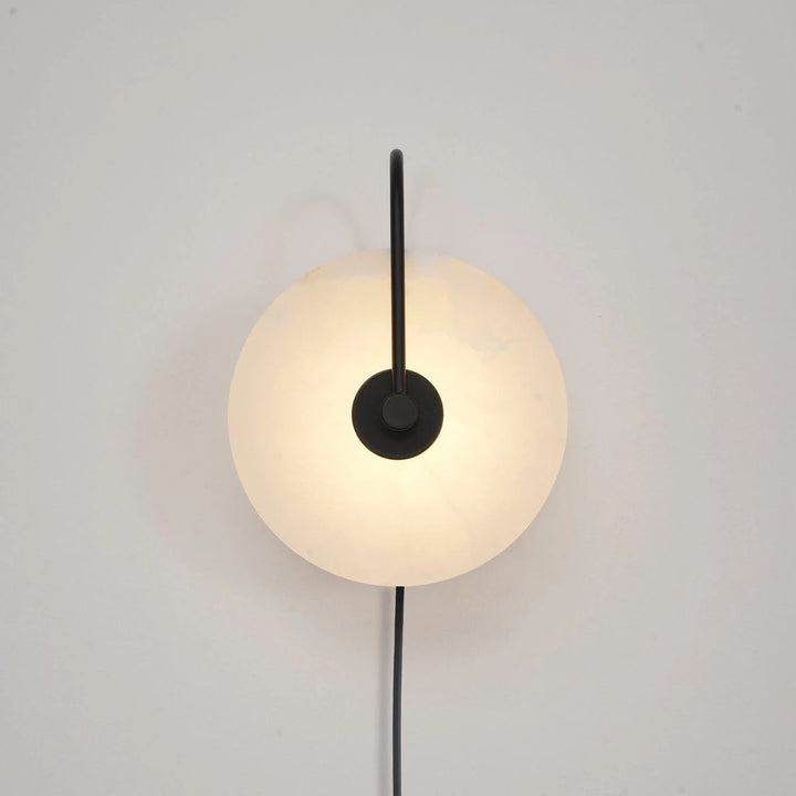 Front view alabaster LED plug-in wall lamp with warm light and distinctive natural stone veining