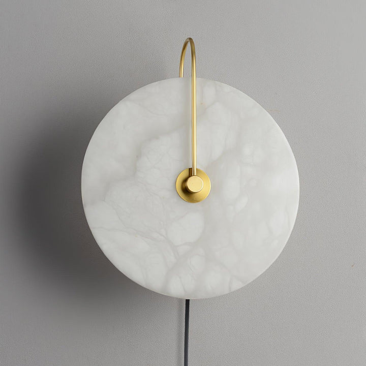 Detailed view of alabaster LED plug-in wall lamp with natural veining and warm diffused light