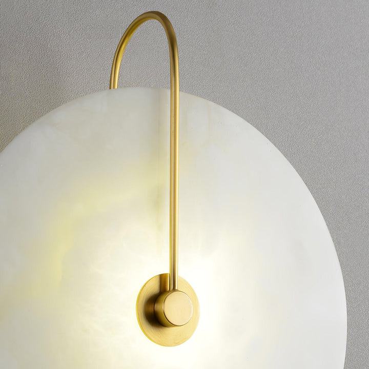 Close-up detail of alabaster LED plug-in wall lamp showing natural veining and soft light diffusion