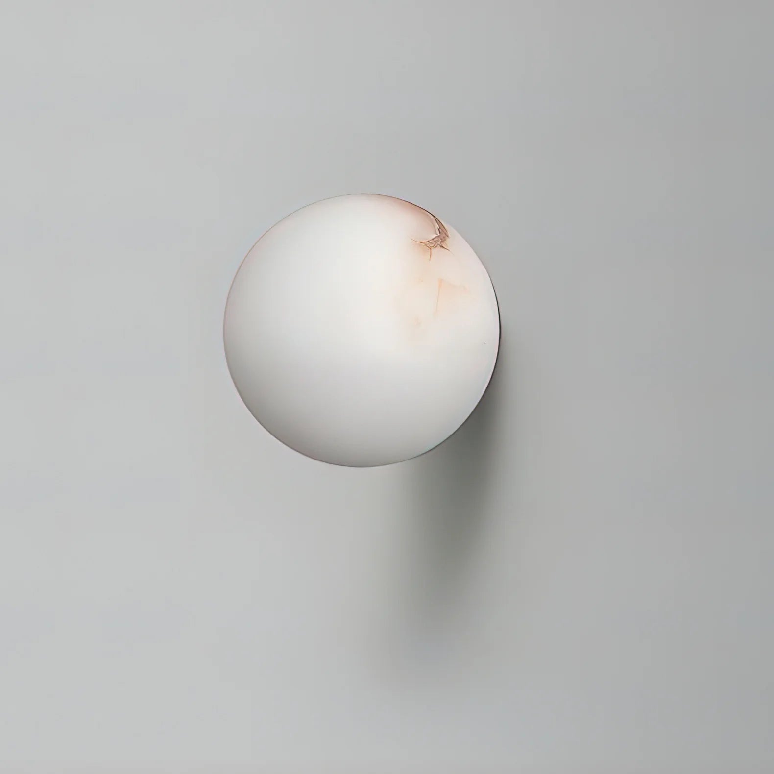 Alabaster mini orb wall lamp front view, modern lighting decor for stylish interiors
