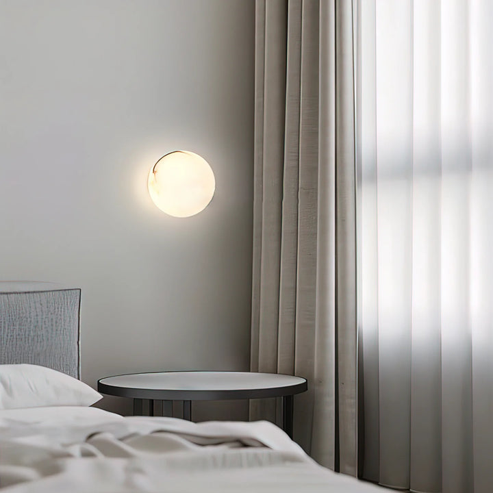 Alabaster mini orb wall lamp bedside view, elegant lighting decor for modern bedrooms