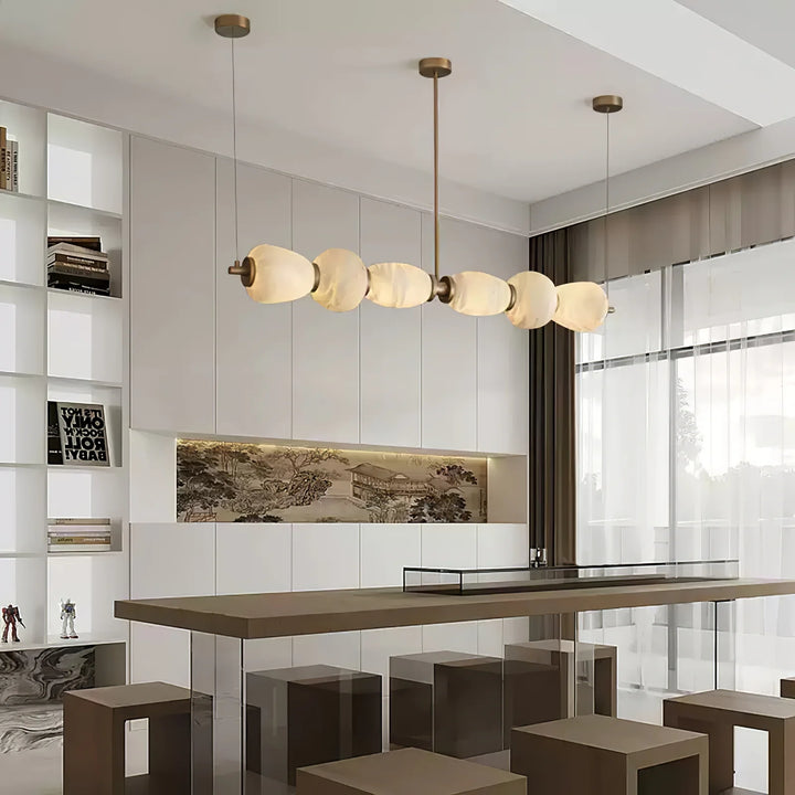 Alabaster Pebble linear chandelier luxury lighting enhancing a dining area with sleek contemporary design