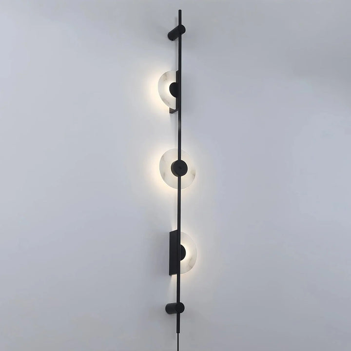 Front view of Alabaster Vertical Plug-In Wall Sconce turned on, modern lighting, elegant décor