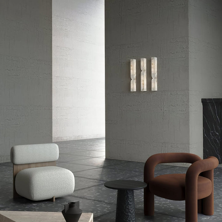 Alabaster wall light sconce installed in modern living room – sleek design with natural stone texture providing soft ambient lighting.