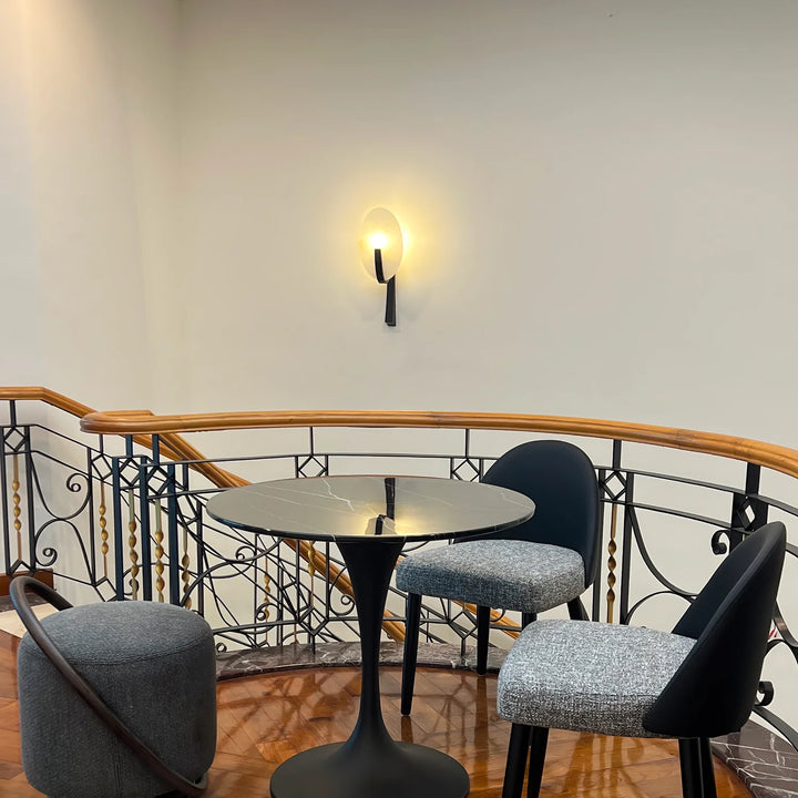 Alice alabaster modern plug-in wall light side view on stairs showcasing sleek and elegant design