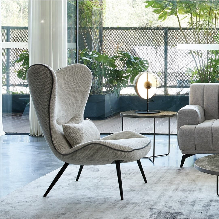  side view of AltaWing custom wingback lounge chair with textured upholstery and contrast piping