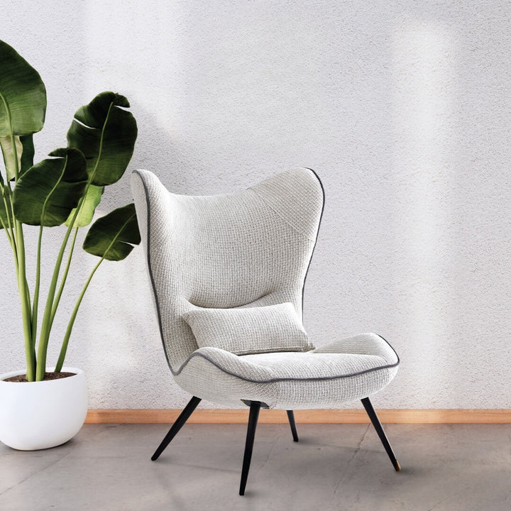  Side view of AltaWing custom wingback lounge chair with textured upholstery and contrast piping