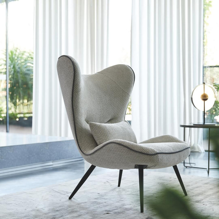  Side view of AltaWing custom wingback lounge chair with textured upholstery and contrast piping