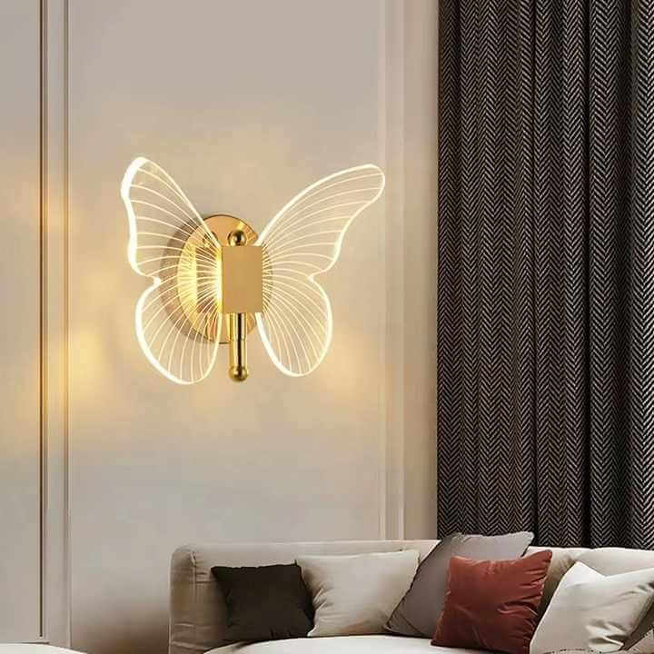 Close-up view of luxury gold butterfly wall lamp showcasing intricate design and polished finish