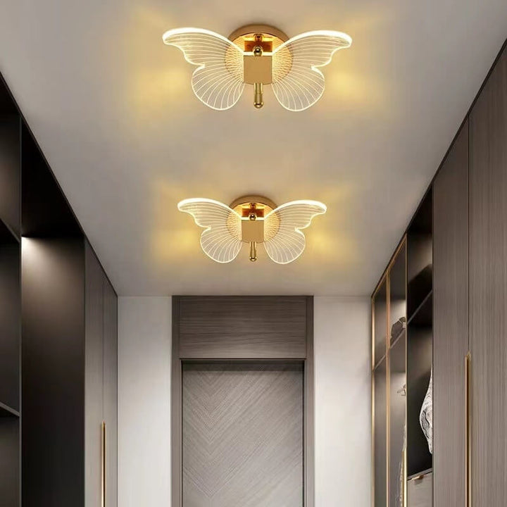 Luxury gold butterfly wall lamp installed near upper roof, showcasing elegant design and polished finish
