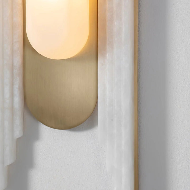 Cascada wall sconce detailed side view showing gold metal and marble wing design, modern lighting