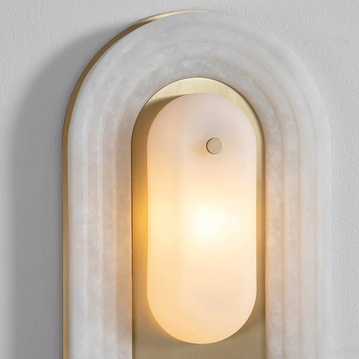 Cascada wall sconce upper side close-up view showing alabaster shade and gold metal details