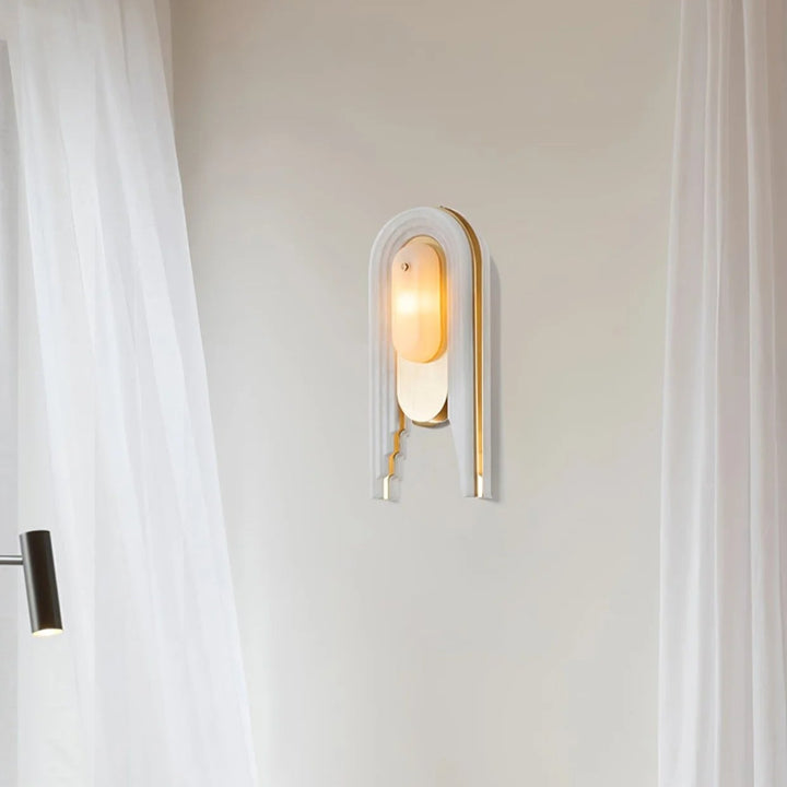 Cascada wall sconce side view on luxury wall with alabaster shade and gold metal accents
