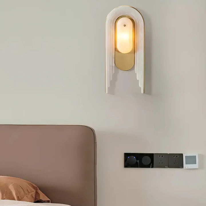 Cascada wall sconce bedside front view with alabaster shade and gold metal accents, modern design