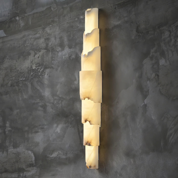 Cascading alabaster wall sconce luxury lighting turned on, shown from a side view for elegant interiors