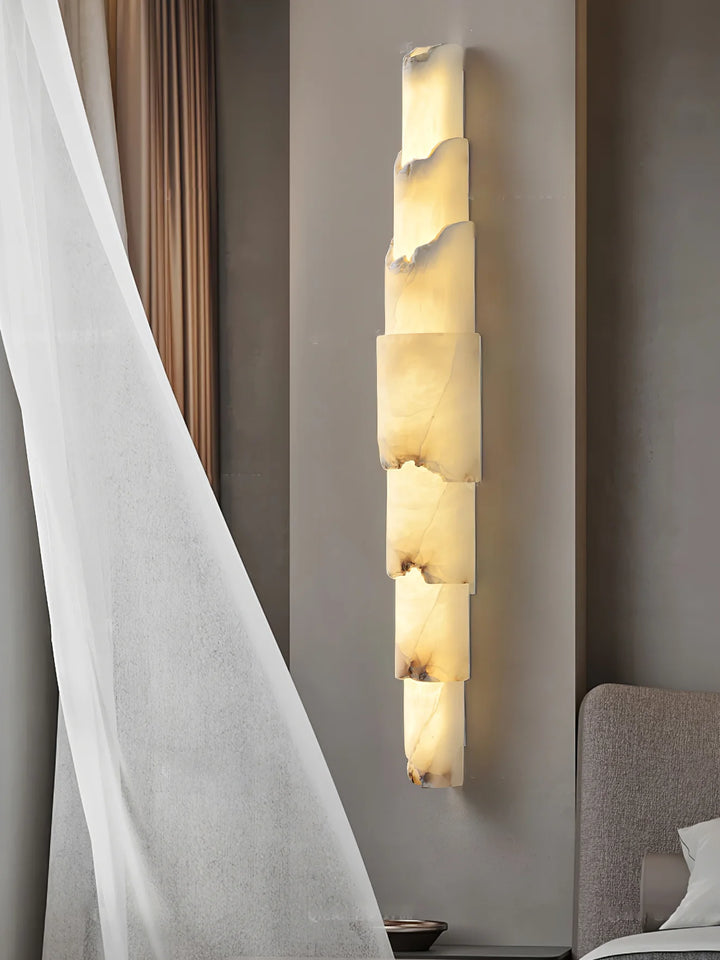 Cascading alabaster wall sconce luxury lighting turned on, shown from a side view for elegant interiors