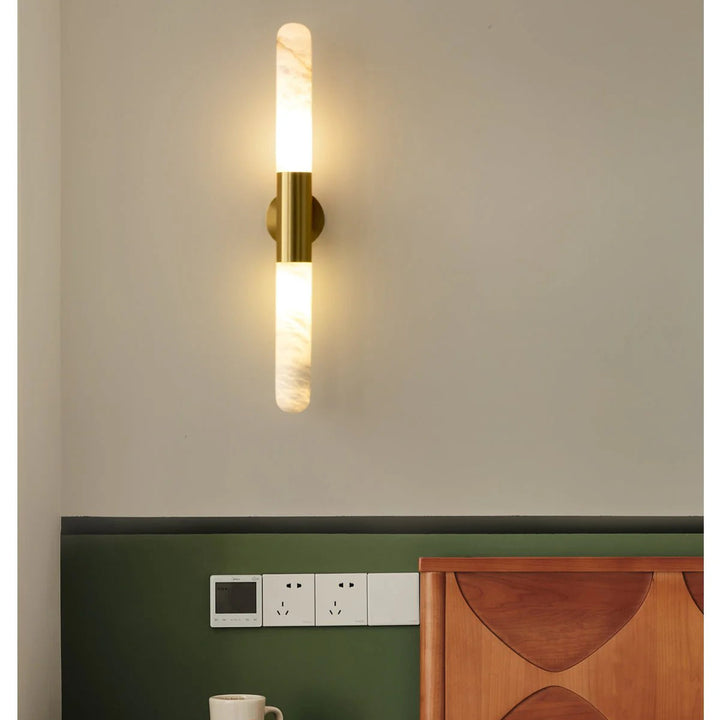 Front view of Cavoya Alabaster Wall Light with golden wall mount, luxury lighting, elegant décor