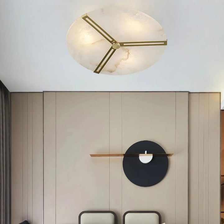 Luxury clocks alabaster ceiling light with brass accents casting warm ambient light in room